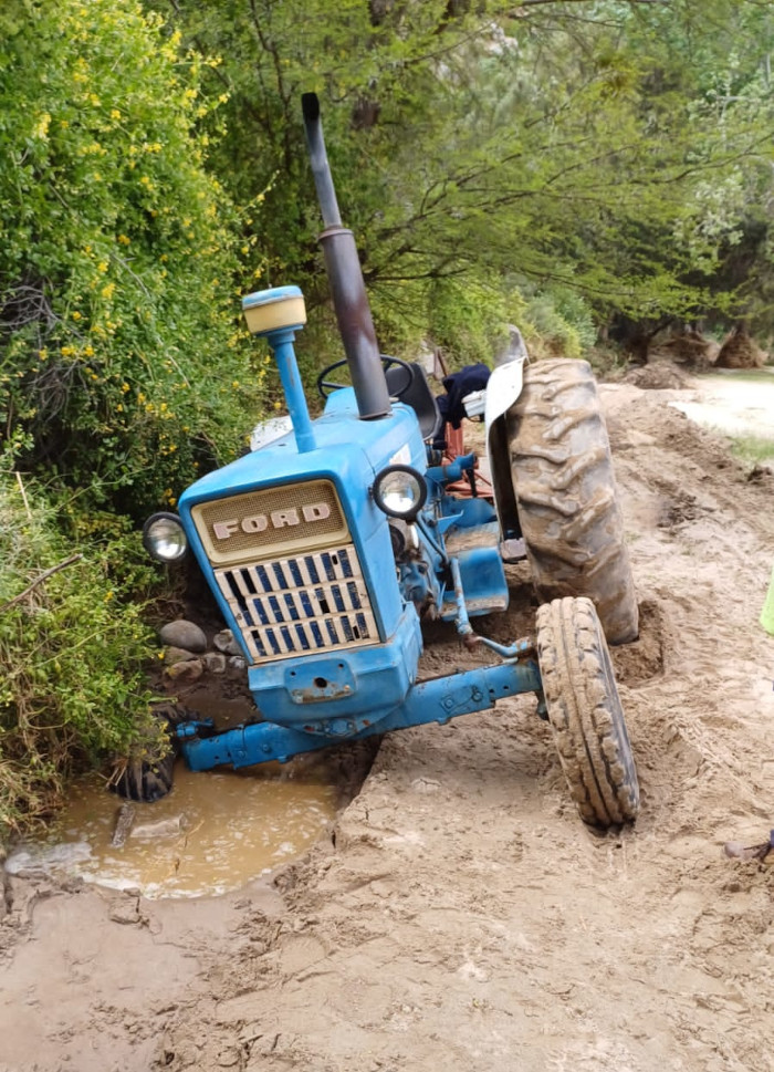 Tractor clearing silt